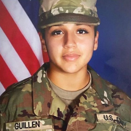Military headshot of Vanessa Guillen in uniform in front of a blue background and the American flag