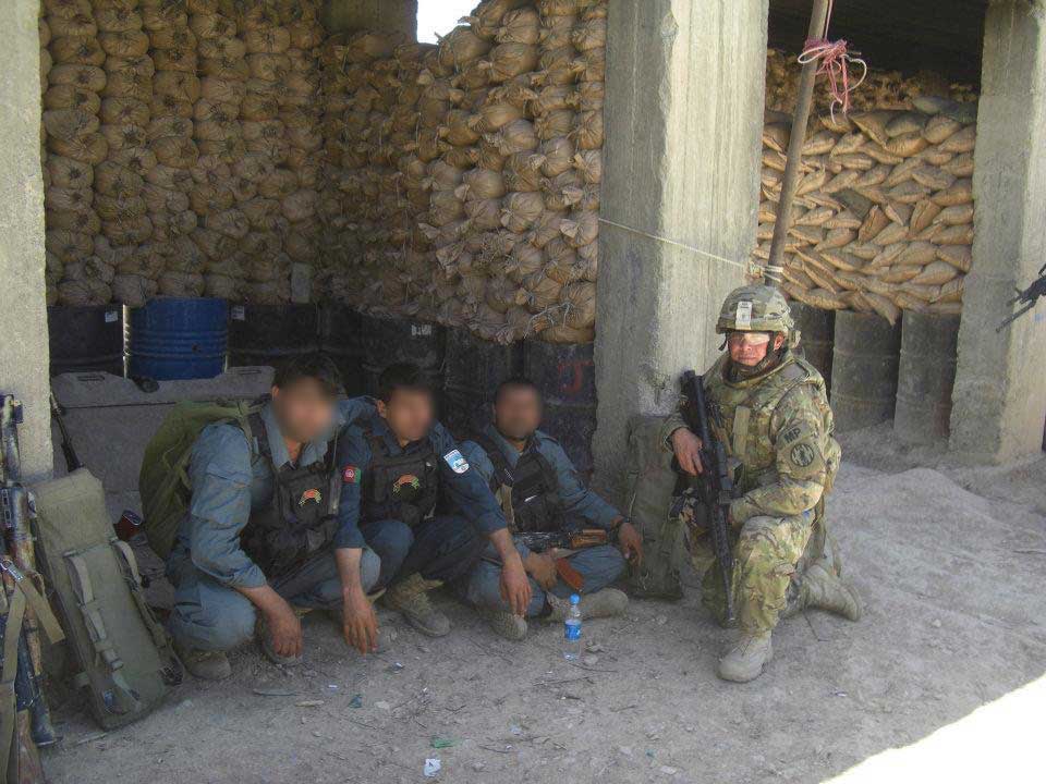 Battle Rattle: Eric Tangeman with three Afghan Uniformed Police officers at an outpost in the Ajuristan District of Ghazni Province, Afghanistan, in 2012. Photo courtesy of the author.