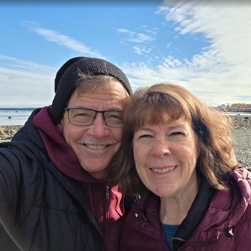 David Grant and his wife smiling at the camera.