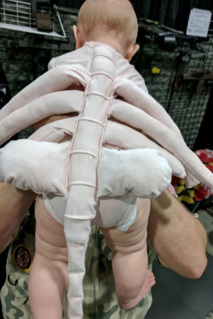 Infant in a facehugger costume from the movie Alien