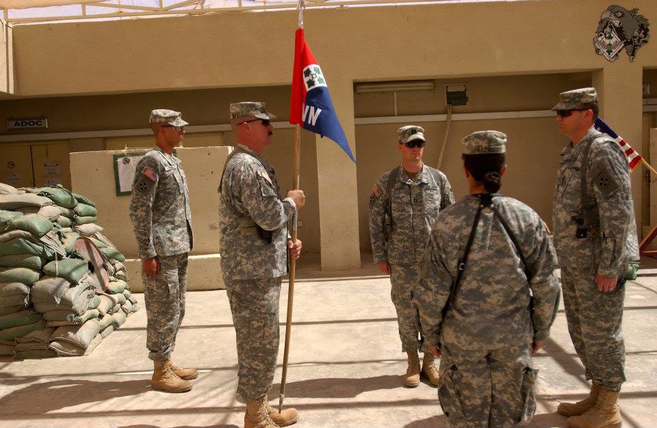 Photo of five US Army soldiers passing the guidon during a change-of-command ceremony at Camp Taji, Iraq. Photo courtesy of the author.