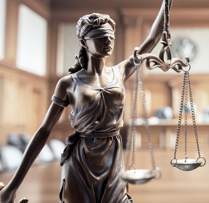 Legal law concept statue of Lady Justice with scales of justice in courtroom background