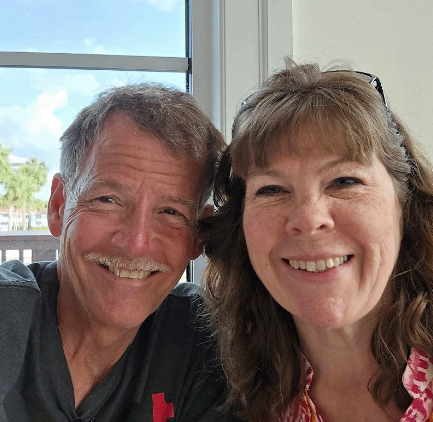 David Grant and wife smiling at the camera.
