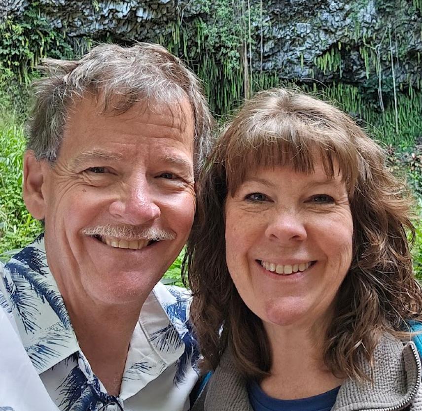 David Grant and his wife smiling at the camera.