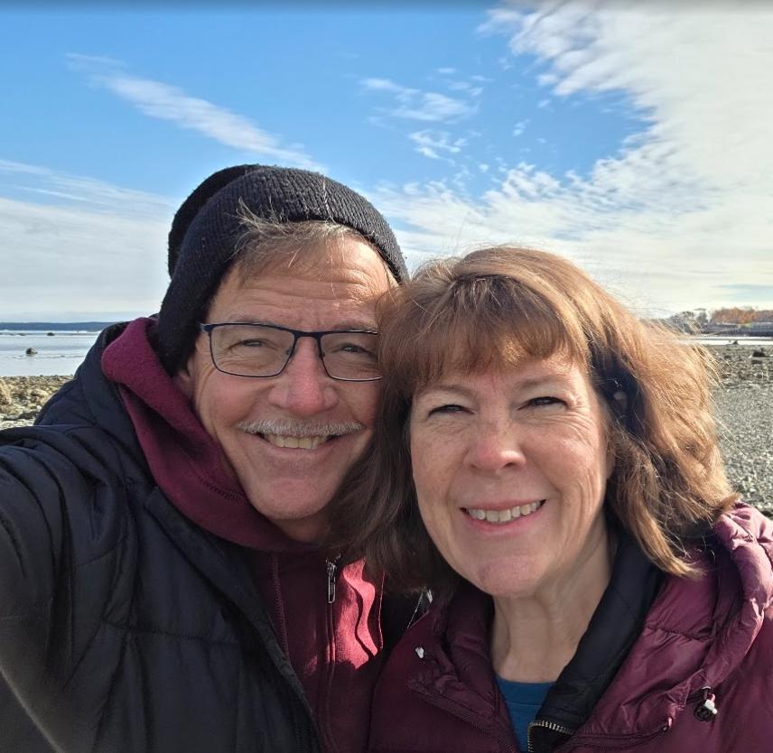 David Grant and his wife smiling at the camera.