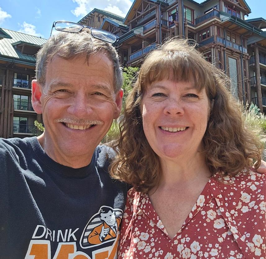 David Grant and his wife smiling at the camera
