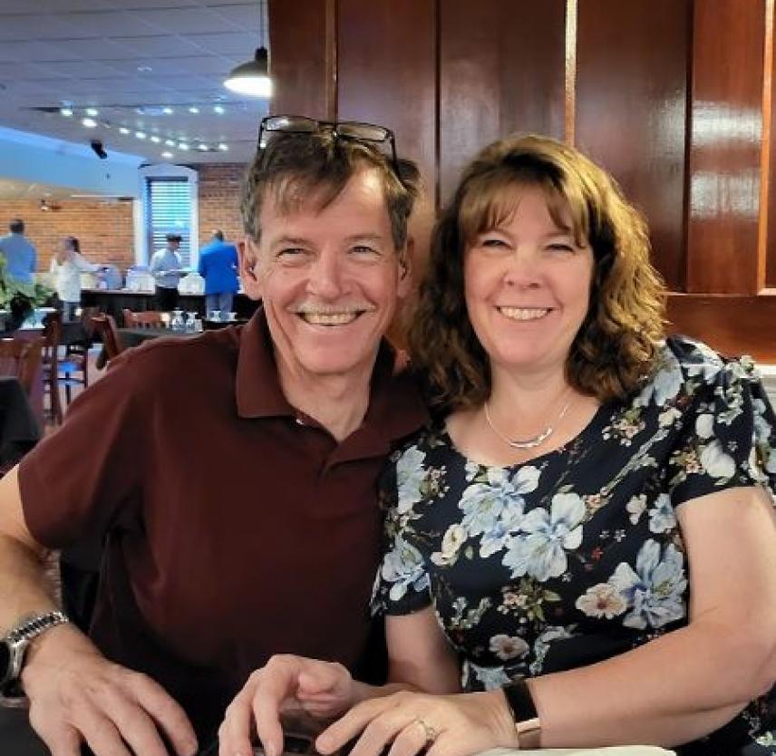 David Grant leans into loss David and his wife smiling seated at a restaurant