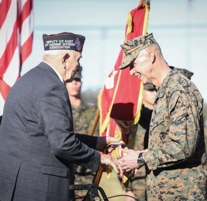 The Commanding General of 1st Marine Division and a member of 1st Marine Division Association place a streamer during the battle colors rededication ceremony on Marine Corps Base Camp Pendleton, CA, 1.31.2020. (U.S.M.C. photo by SSgt Melissa Marnell)