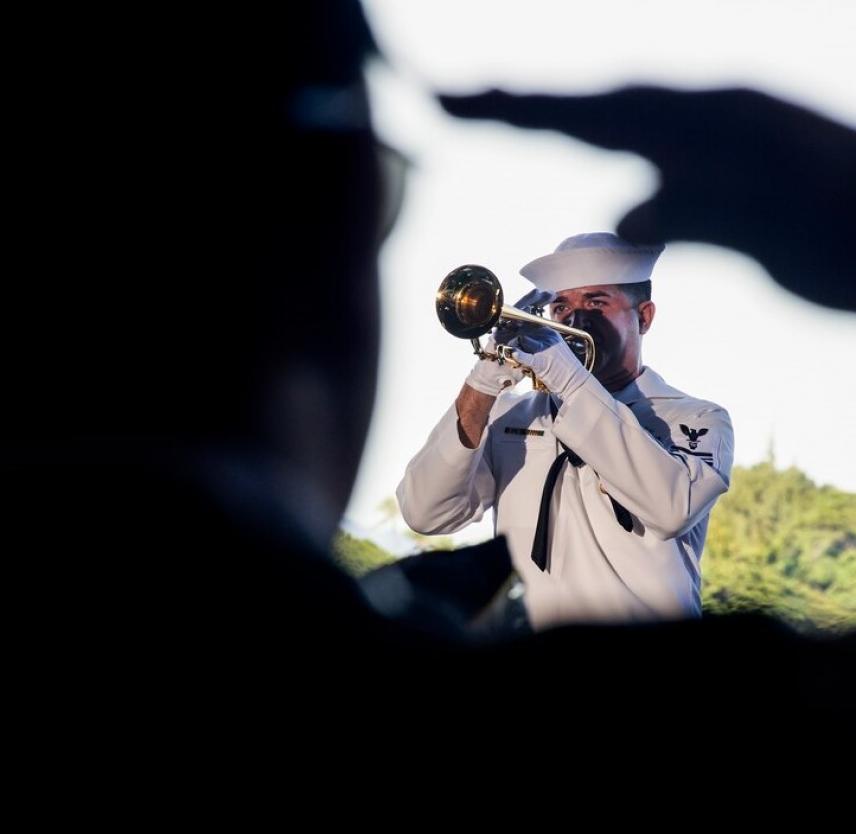 Navy Petty Officer 1st Class Brandon Barbee performs taps during a 75th commemoration event of the attacks on Pearl Harbor at Joint Base Pearl Harbor-Hickam, Hawaii, Dec. 7, 2016. Navy photo by Petty Officer 2nd Class Laurie Dexter.