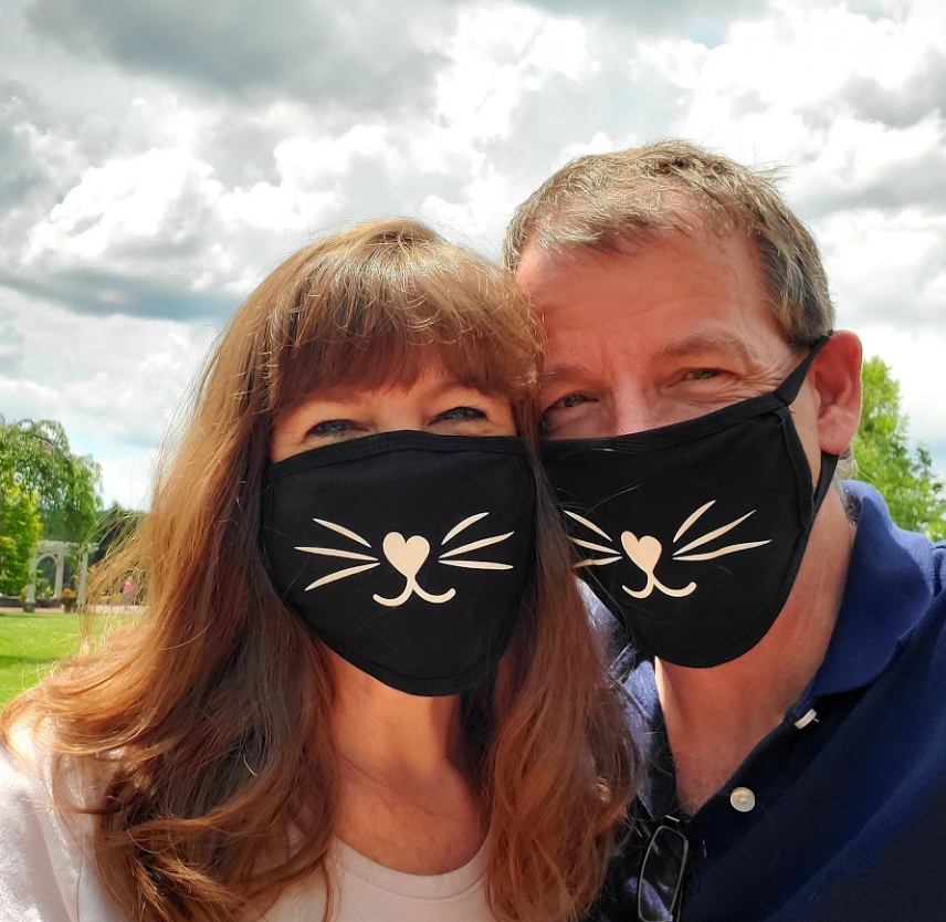 David Grant and his wife wearing black face masks.
