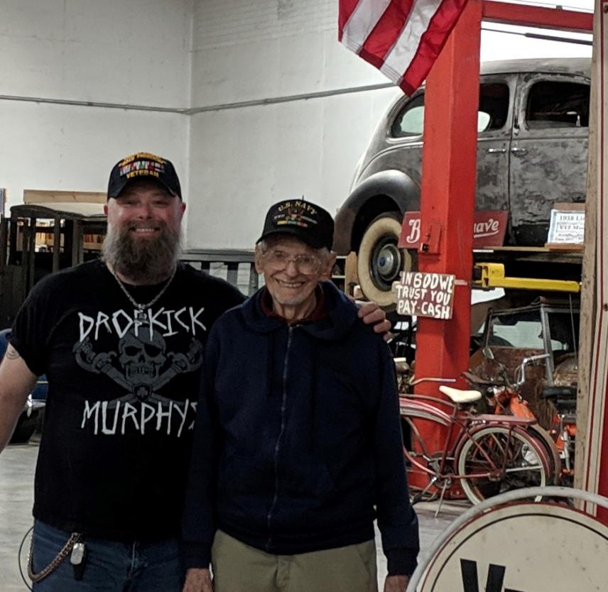 Russ Ware (left) and Grandpa Russ Ware (right) in an antique car museum