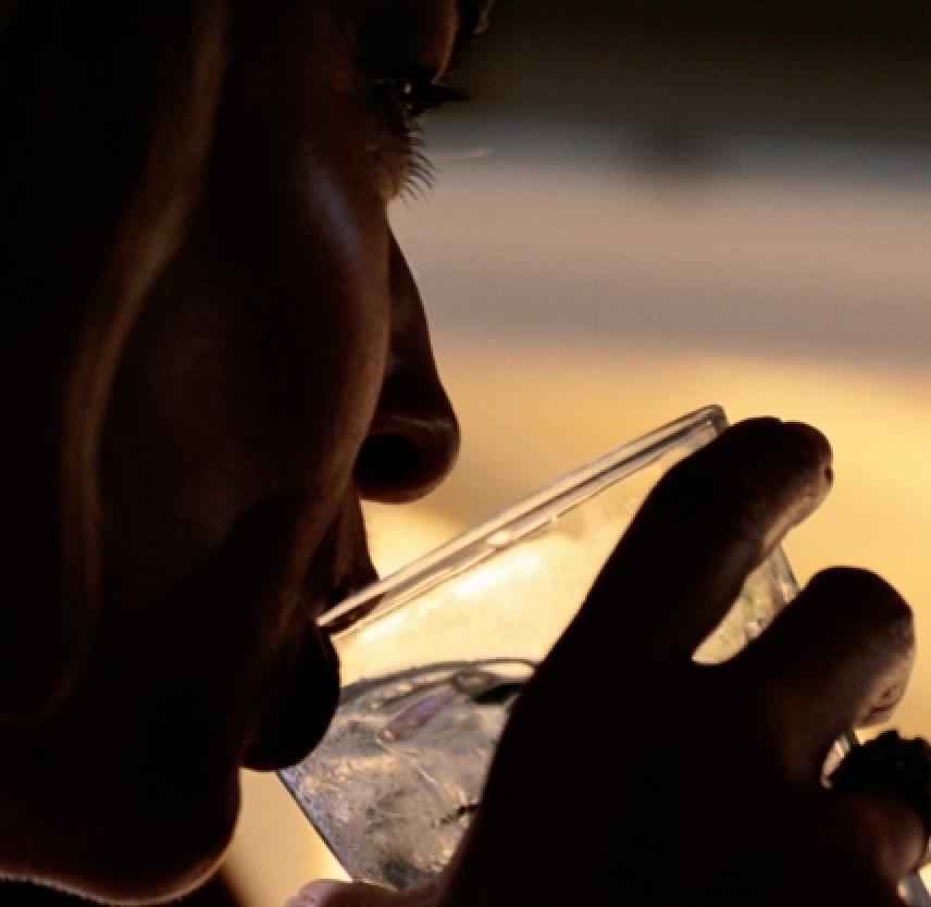 Person drinking at sunset