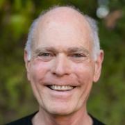 Photo of Marty Yura wearing a black t-shirt and a great big smile