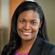 Dr. Tamar Rodney wearing a black blazer and fuchsia top