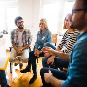A group of people smiling and talking.