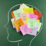 Drawn profile of a head with sticky notes showing lightbulbs.