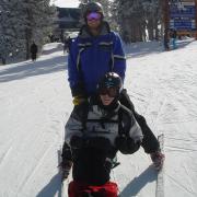 U.S. Army Veteran Jason Ehrhart sit-skiing with an instructor