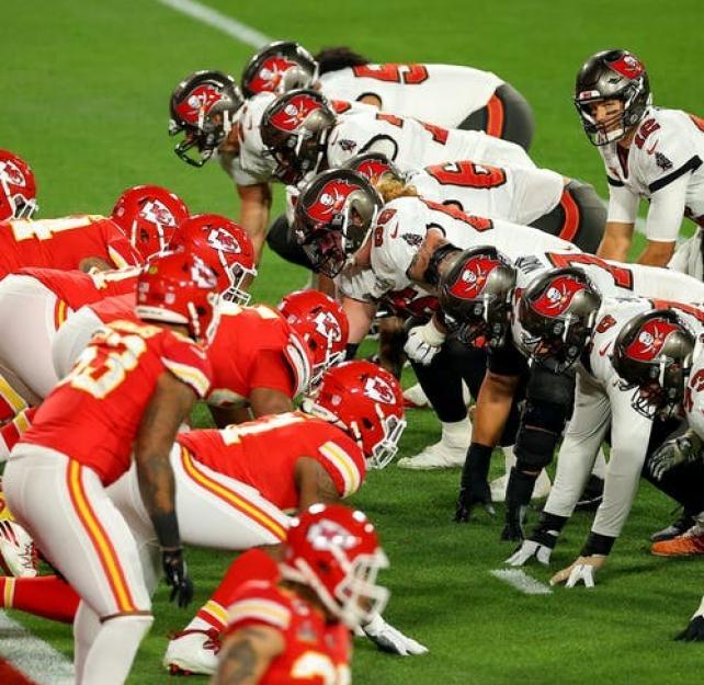 Football players face each other on a field, photo by Kevin C. Cox/Getty Images Sports