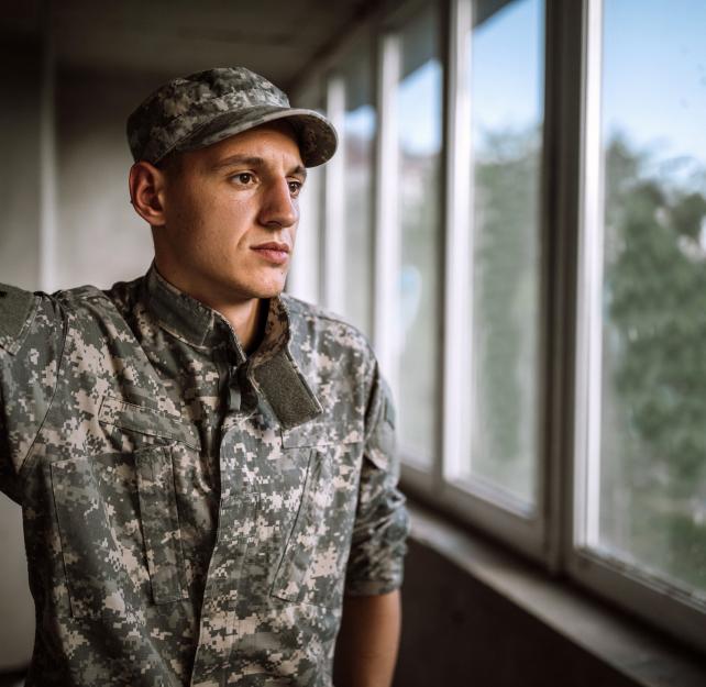 Service member looking out a window.