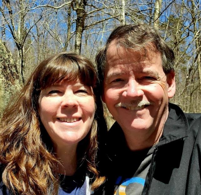 David Grant and his wife smiling at the camera.