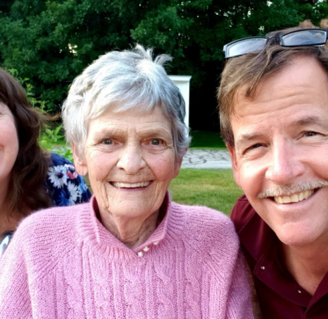 David Grant, his mother, and his wife smiling at camera