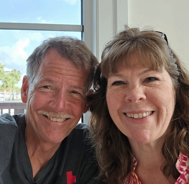 David Grant and wife smiling at the camera.