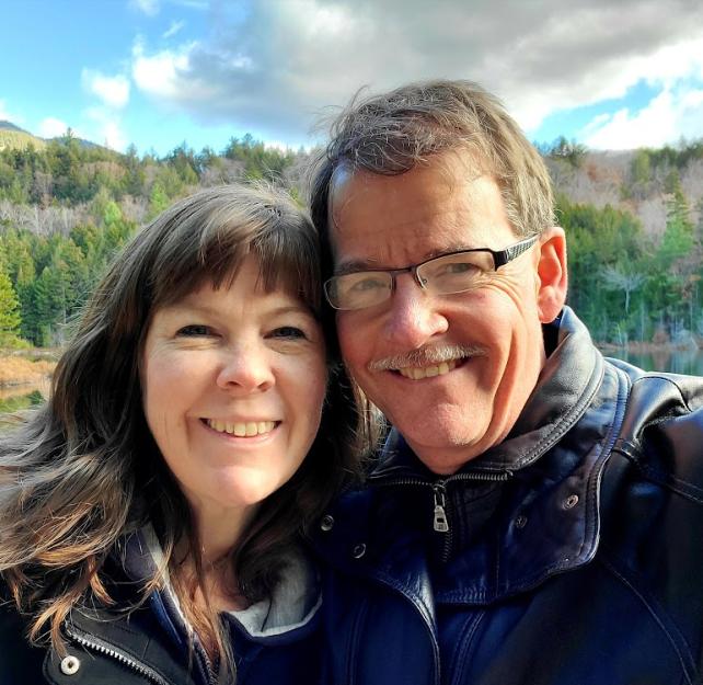 David Grant and his wife smiling at the camera.
