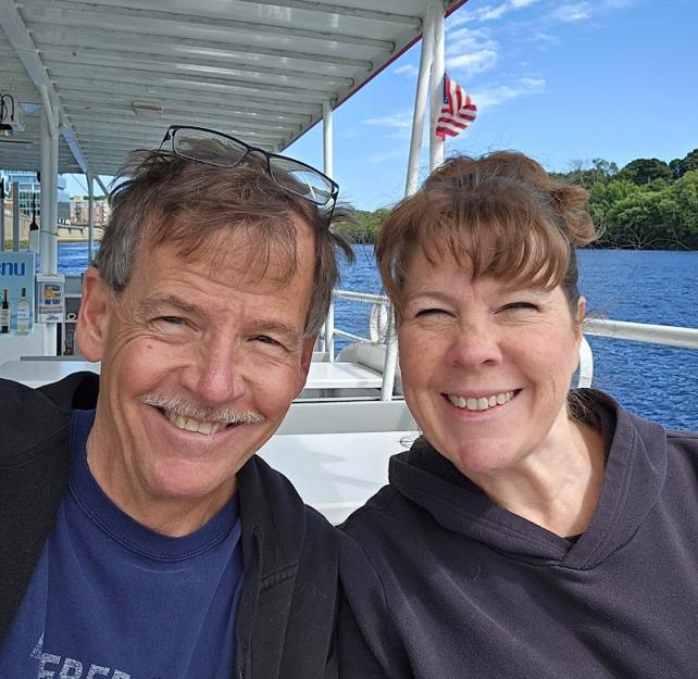 David Grant and his wife smiling while on a boat.
