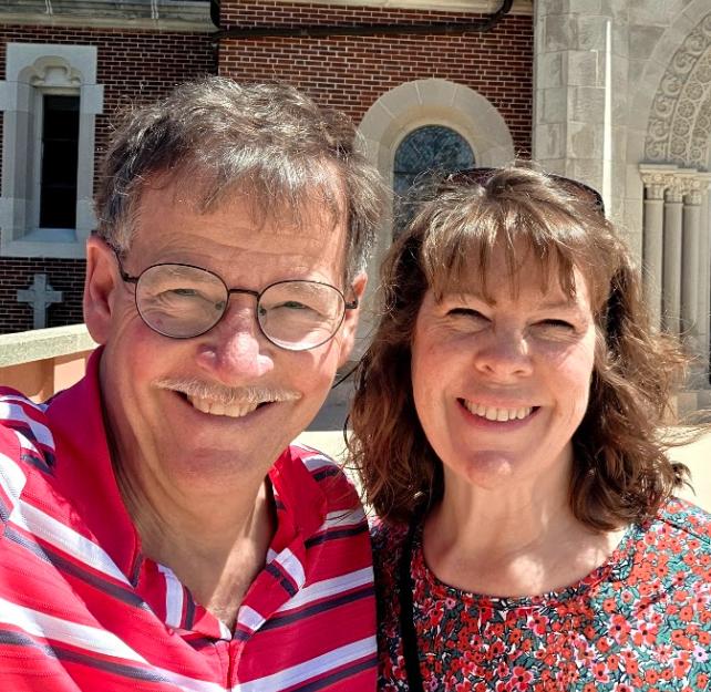 David Grant and his wife smiling into the camera.