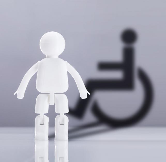Graphic representation of a white figurine standing in front of a disabled wheelchair symbol in black