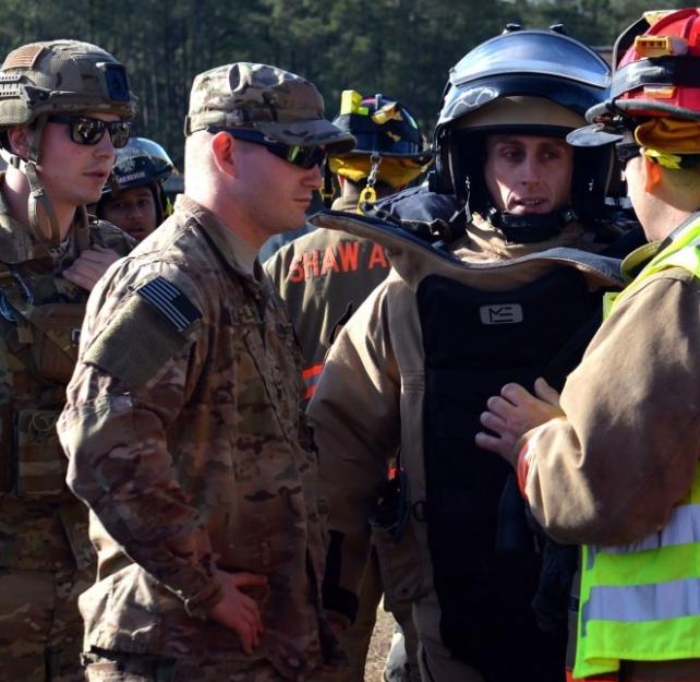 U.S. Airmen discuss a plan of action before participating in a joint hazardous material training at Shaw Air Force Base, S.C., Jan. 19, 2017. (U.S. Air Force photo by Airman 1st Class Christopher Maldonado)