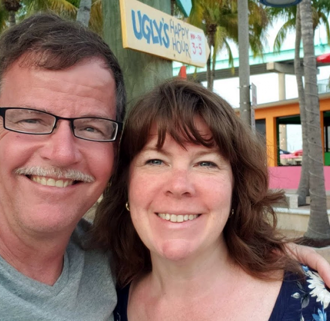 David Grant and his wife smiling at the camera