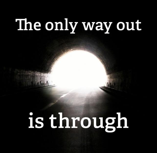 Bright light at the end of a dark tunnel with text: The only way out is through