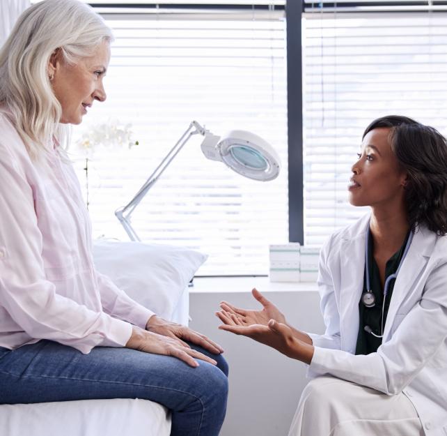 older woman talking with a doctor