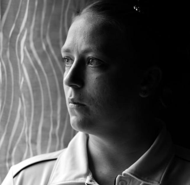A black and white portrait of Angela Peacock looking to the left