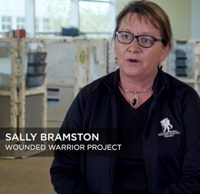 Screenshot of Sally Bramston wearing a black top and black jacket with a white Wounded Warrior Project logo on the left