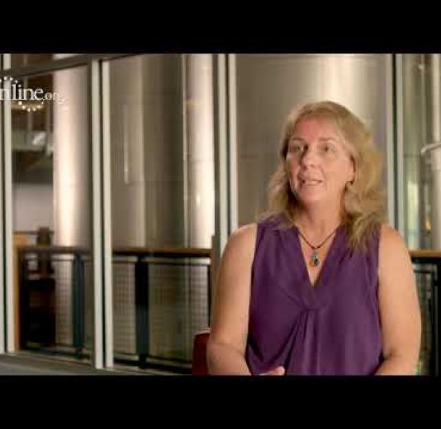 Michelle Ranae Wild in front of silver silos.