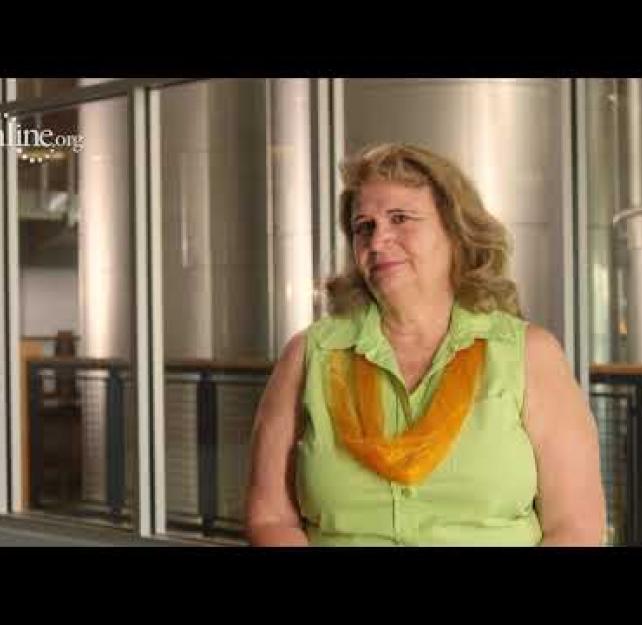 Kristi Kragthorpe in front of silver silos.