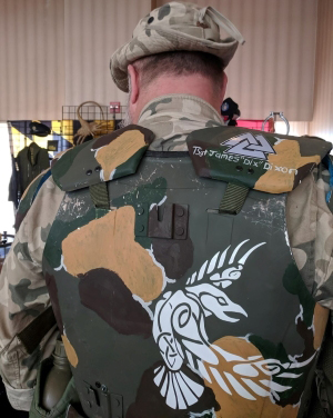 Back of cosplay armor painted in camo with the text in white on the right shoulder reading: TSgt James "Dix" Dixon